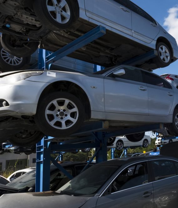 Junk cars piled over one another